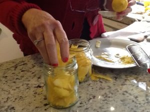 Filling the jars with lemon skin